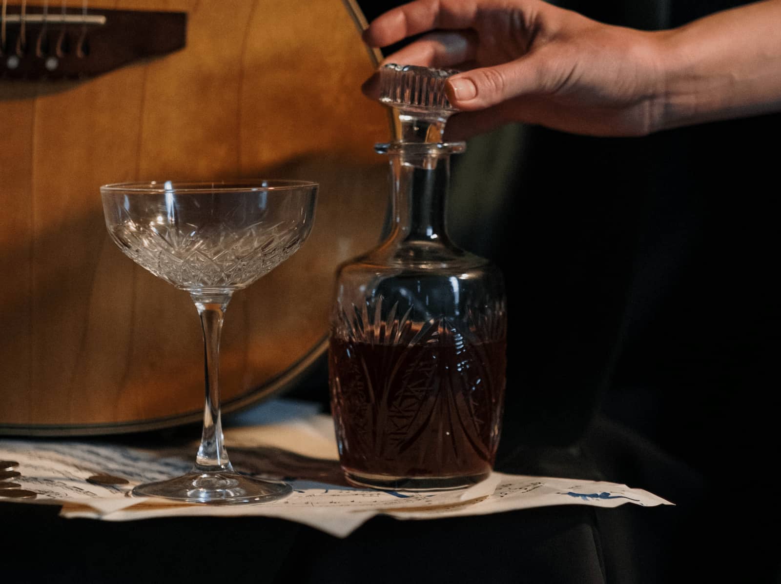Glass decanter filled with rum next to an empty glass