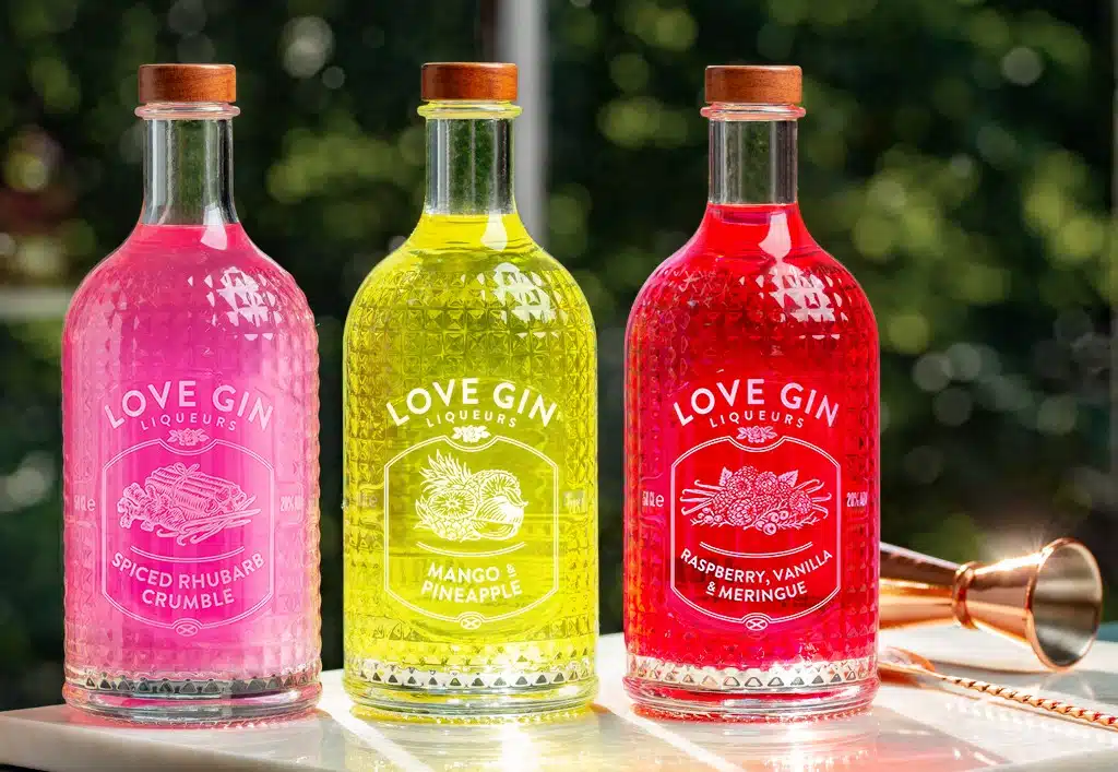Three glasses of Love Gin with an greenery background