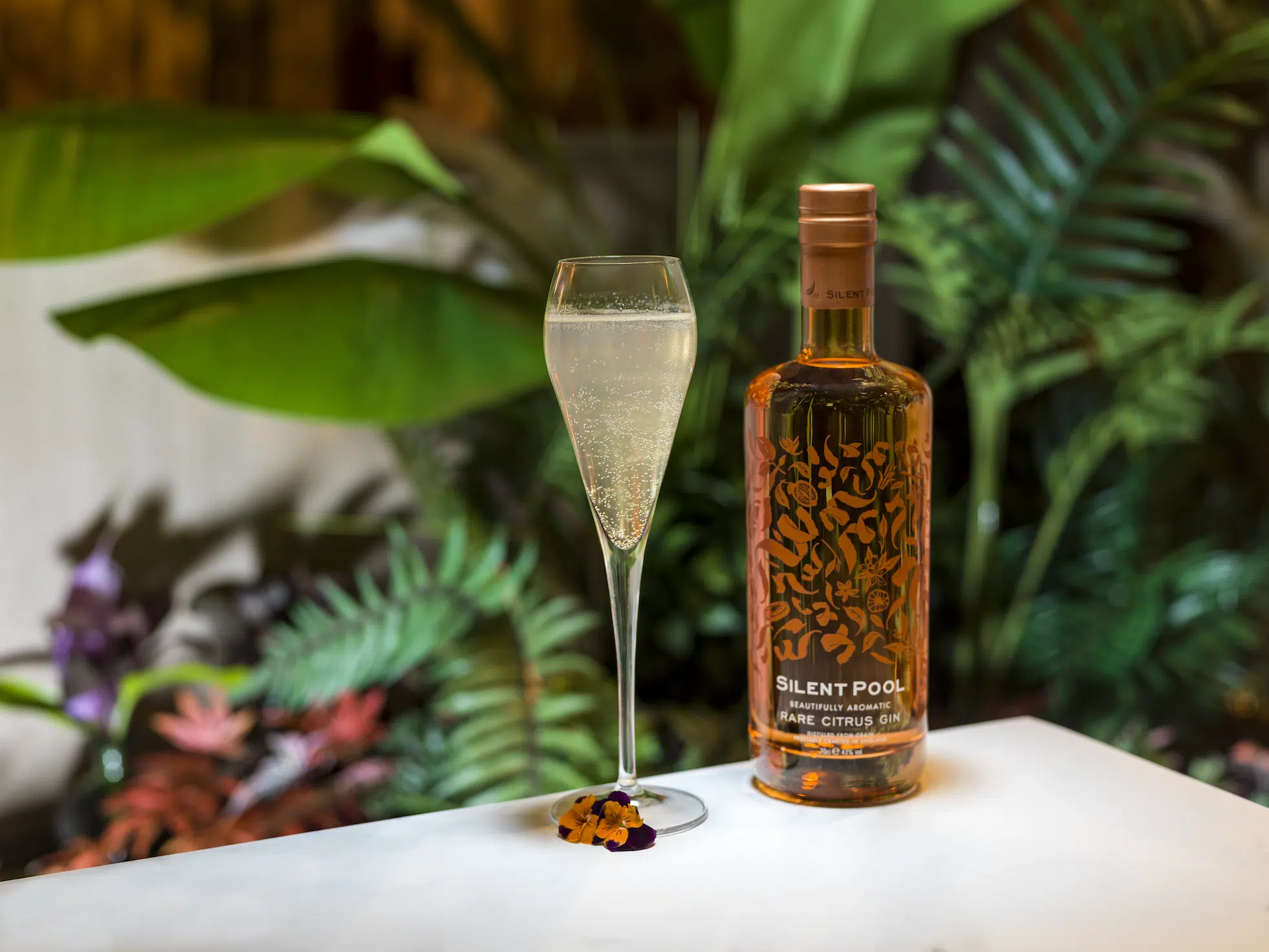 Silent Pool Rare Citrus Gin, with a garden background