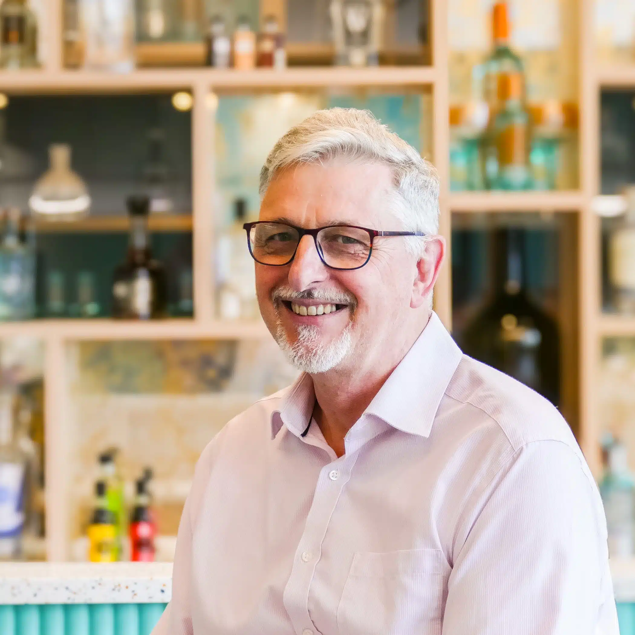 Peter Singleton Man with glasses in pink shirt