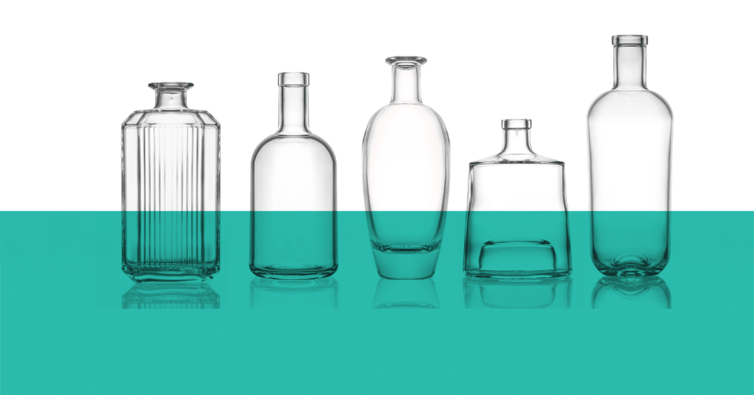 A line of clear glass bottles on a white and green background.